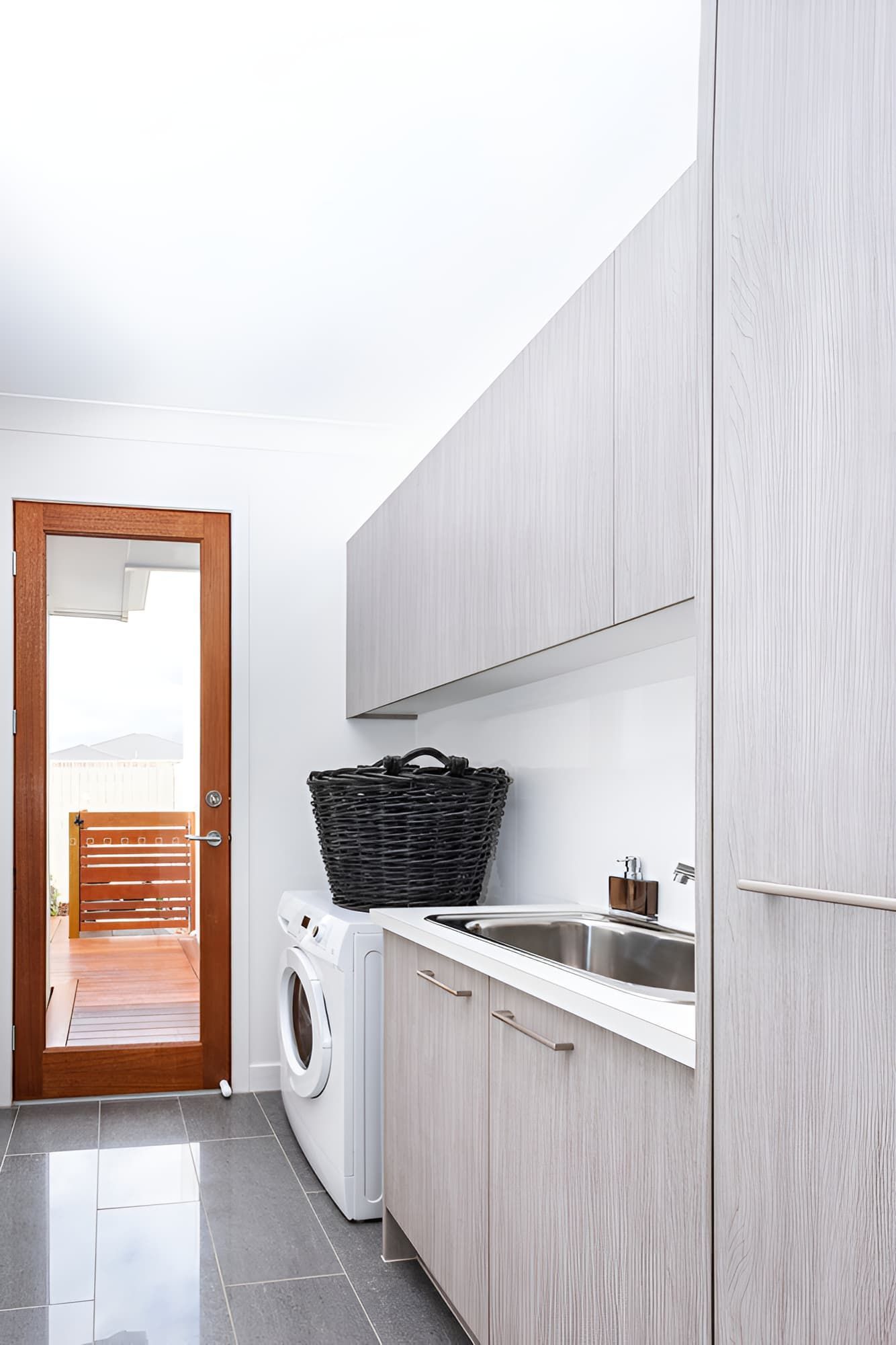 A Laundry Room With a Washer and Dryer and a Sink — Simpson's Plumbing & Maintenance Service in Dakabin, QLD