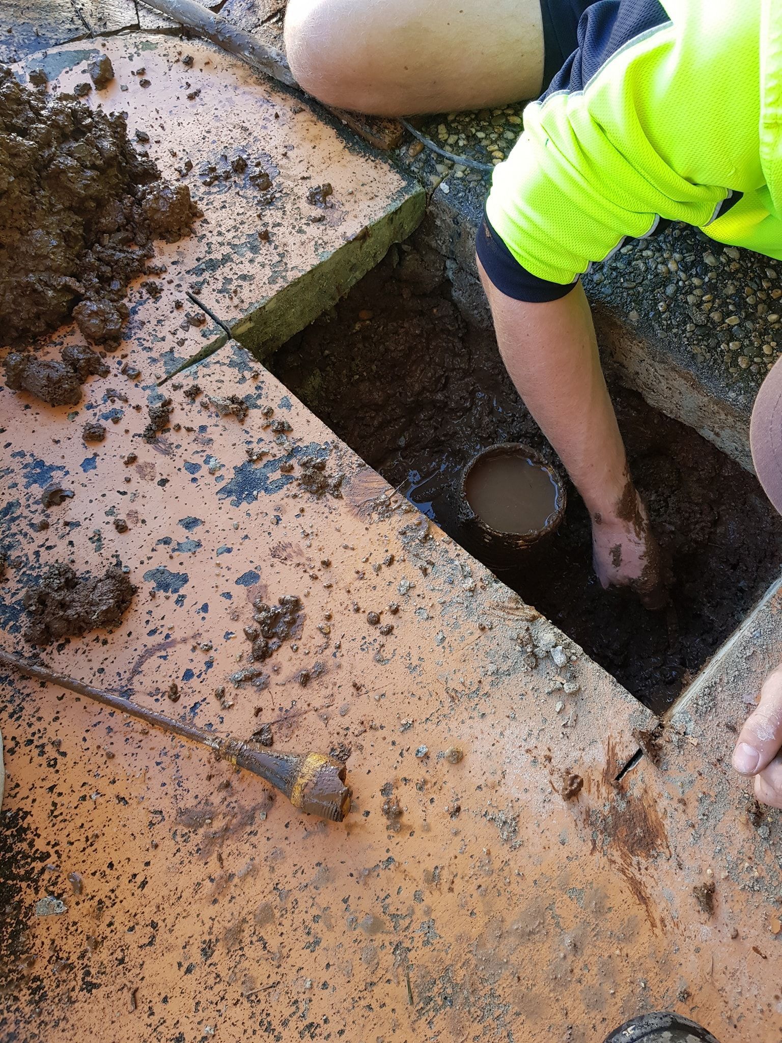 A Person is Digging a Hole in the Ground — Simpson's Plumbing & Maintenance Service in Dakabin, QLD