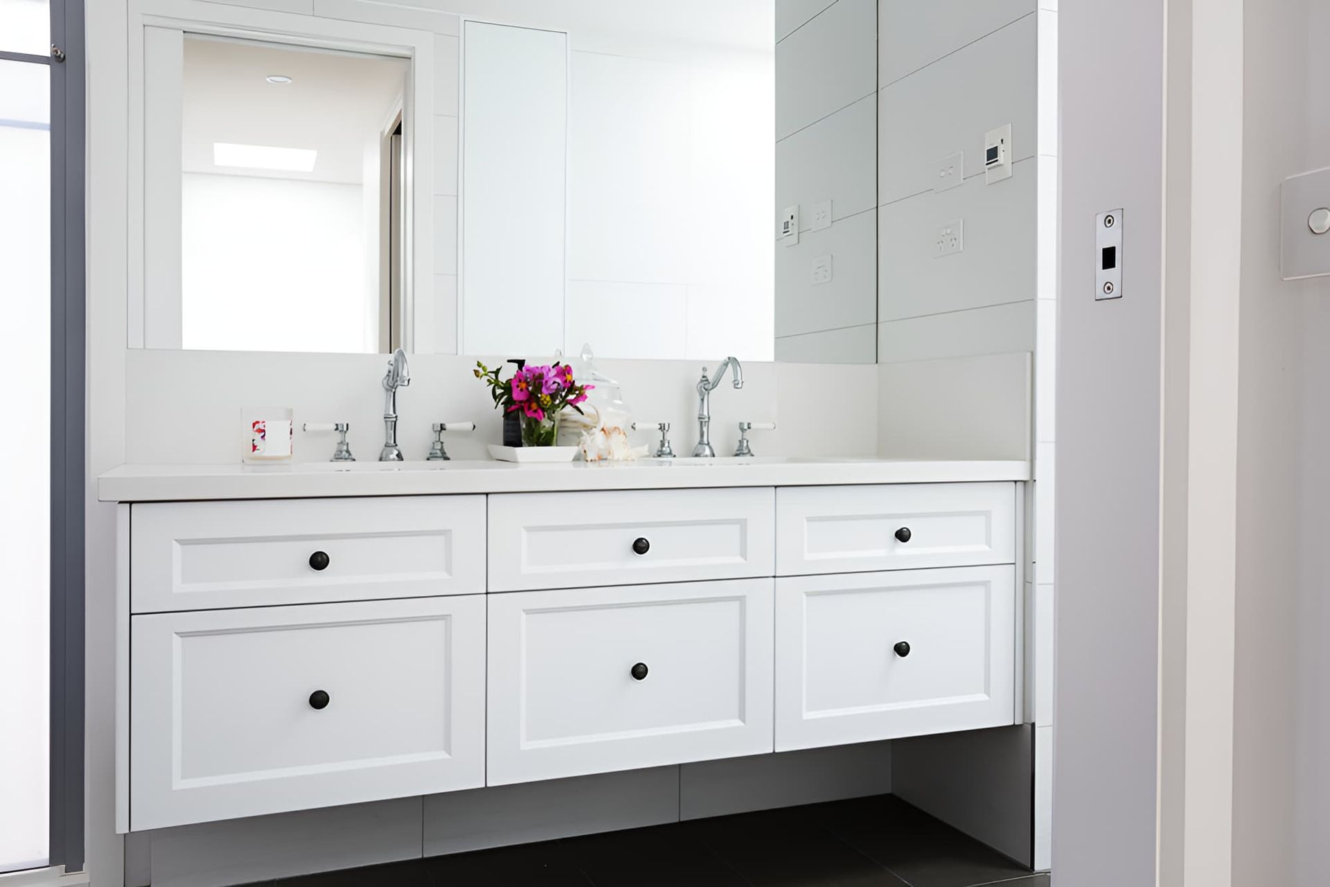 A Bathroom With Two Sinks and a Mirror — Simpson's Plumbing & Maintenance Service in Dakabin, QLD