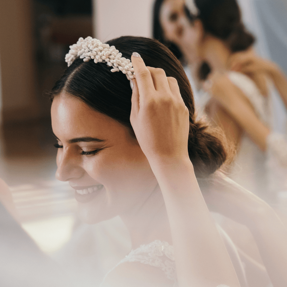 a woman wearing a headband with white flowers on it
