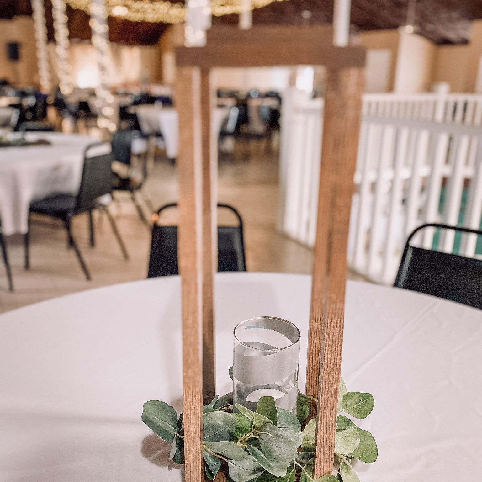 a table with a vase of flowers and a candle on it .