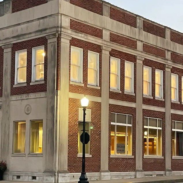 a large brick building with lots of windows and a street light in front of it