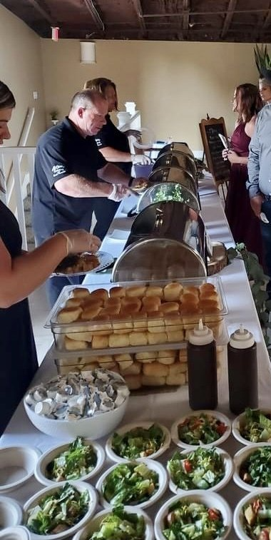 Guests Being Served at Buffet Table