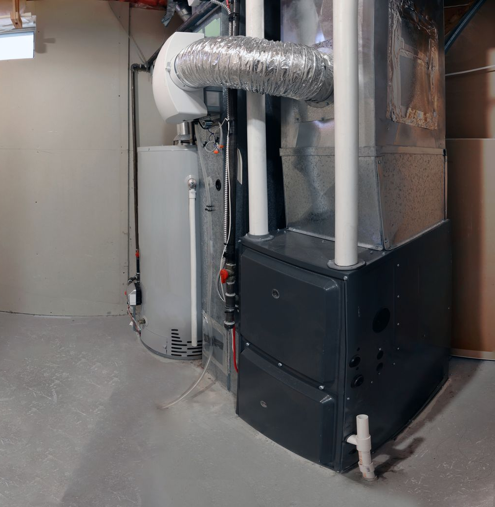 A technician uses a screwdriver to repair the internal electrical components of a wall-mounted boiler.