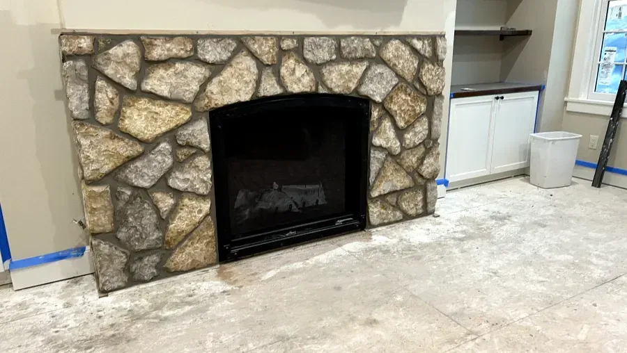 There is a fireplace in the middle of the room.