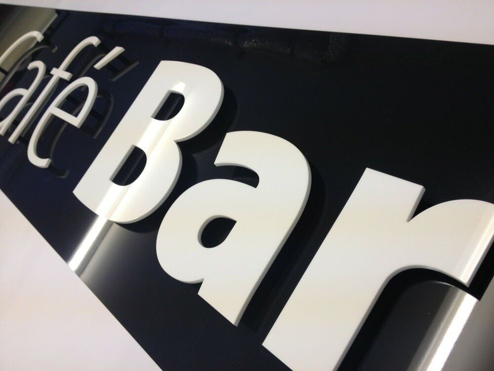 Plastic letters with a black plastic backer.