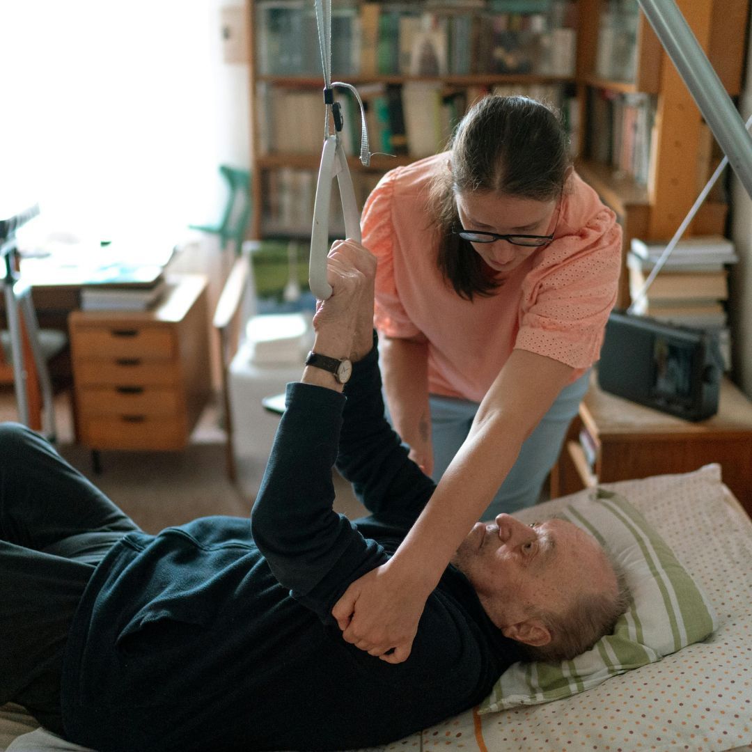 A home health nurse and an elderly patient.