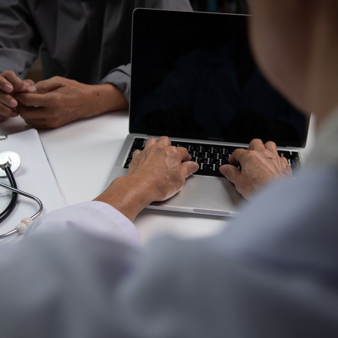 Nurse typing on a computer.