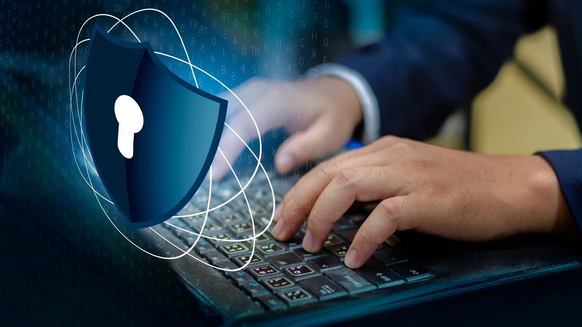 A man typing on a computer with a cybersecuity lock.