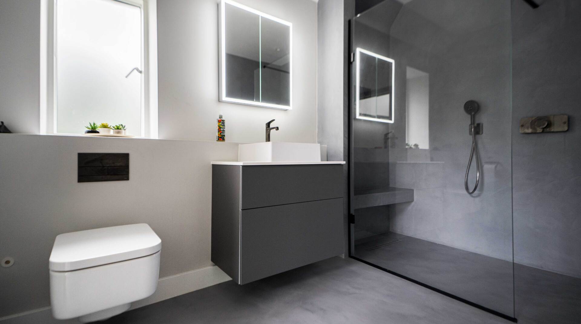 Dark grey resin floors in bathroom