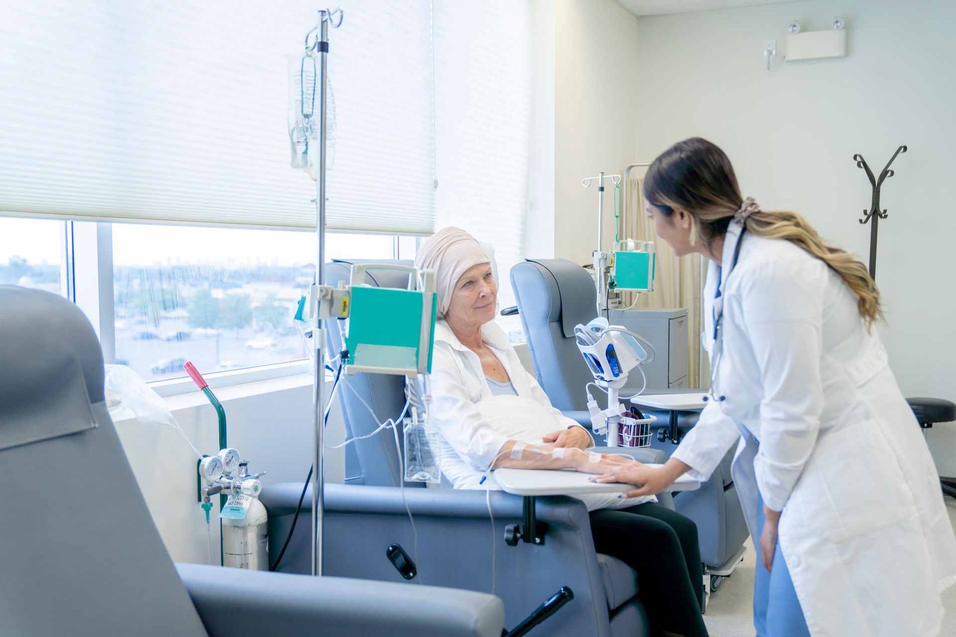 A doctor is talking to a patient in a hospital room.