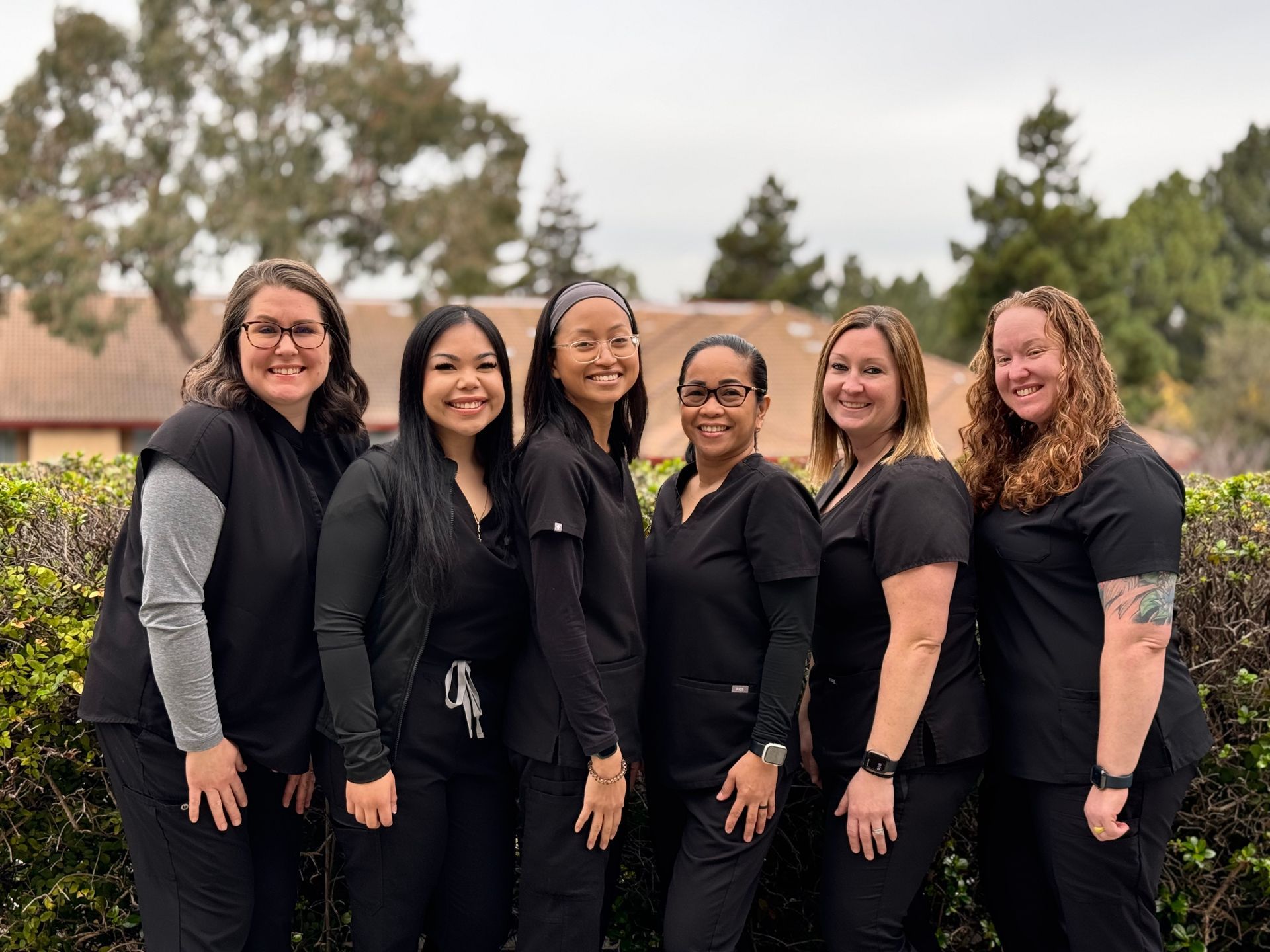 A group of women in scrubs are posing for a picture