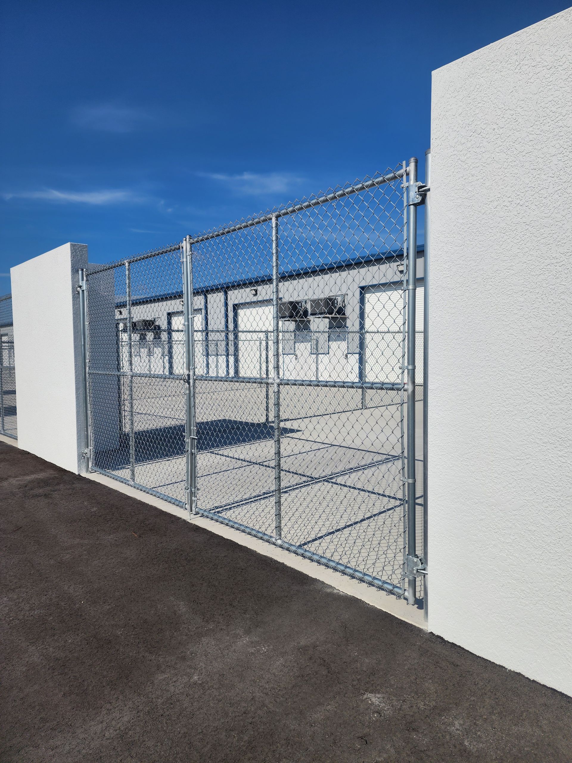 A white fence is sitting in the middle of a grassy field.