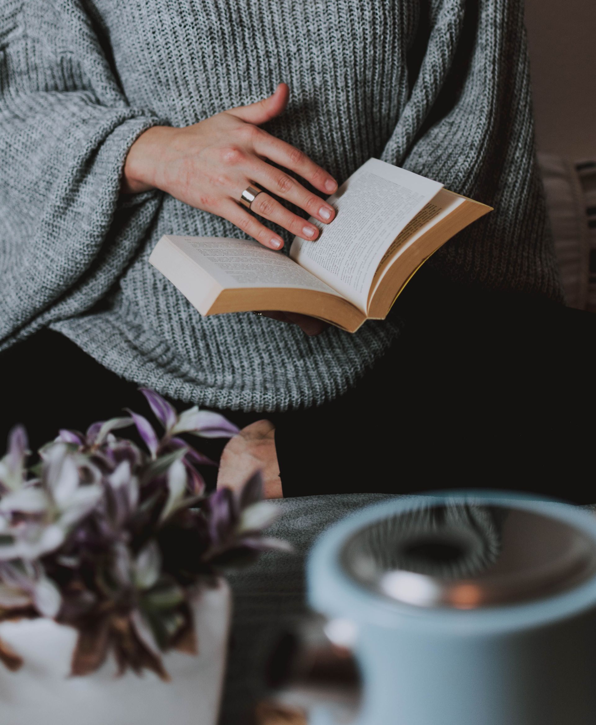 A welcoming psychic advisor preparing a reading in a calm studio.