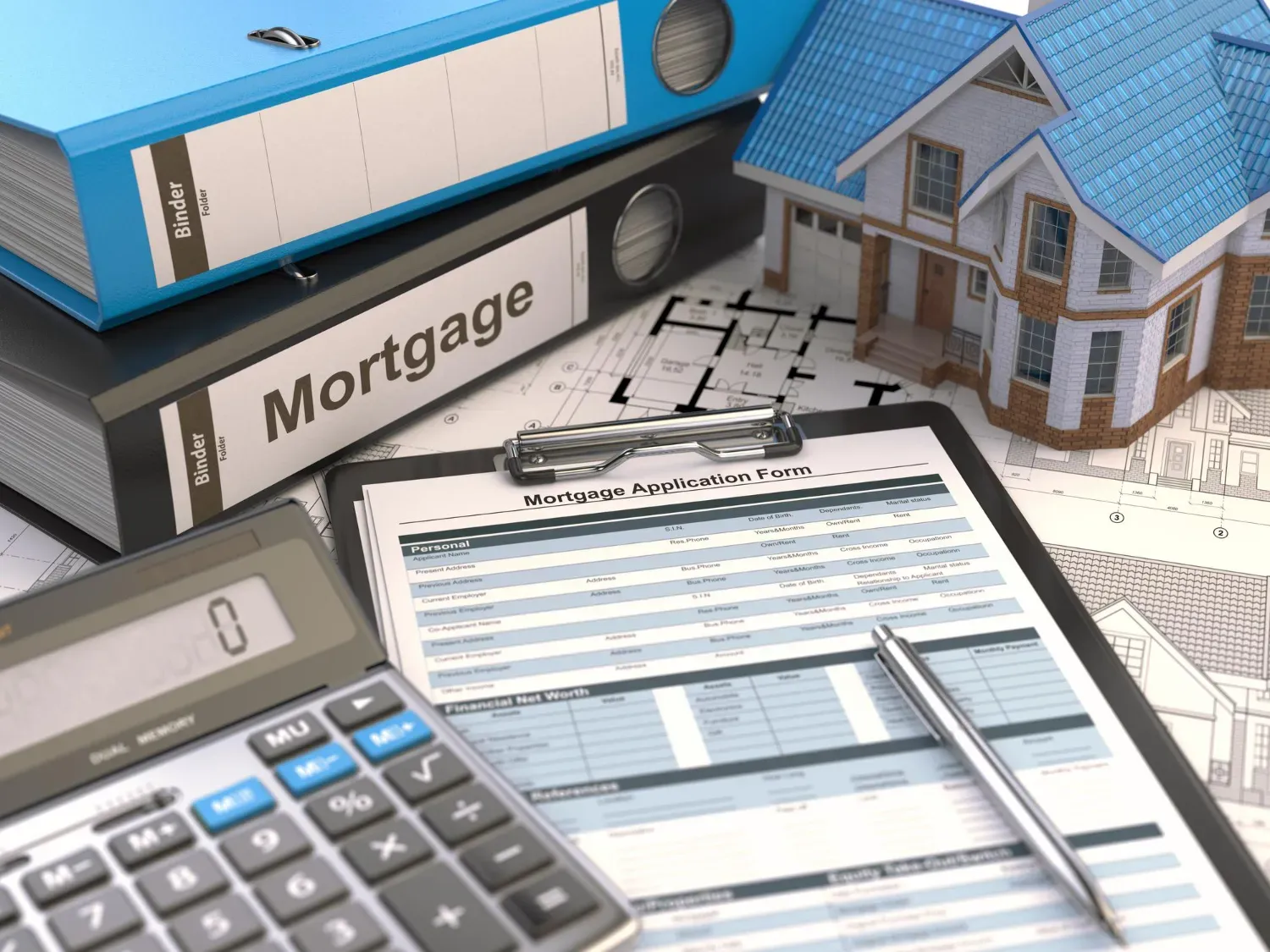 A calculator is sitting on top of a clipboard next to a model house.