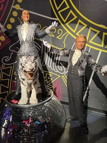 A statue of a man standing next to a statue of a tiger