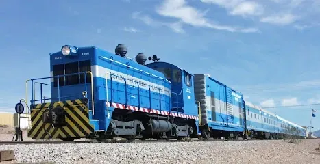 A blue and white train is sitting on the tracks.