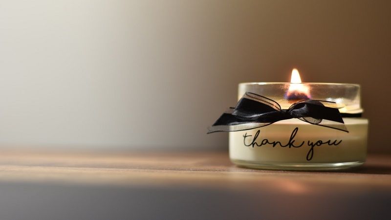 Memorial candle with thank you message representing compassionate Savage, MN cremations and remembrance services