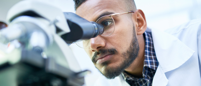 Scientist looking through a microscope in a laboratory
