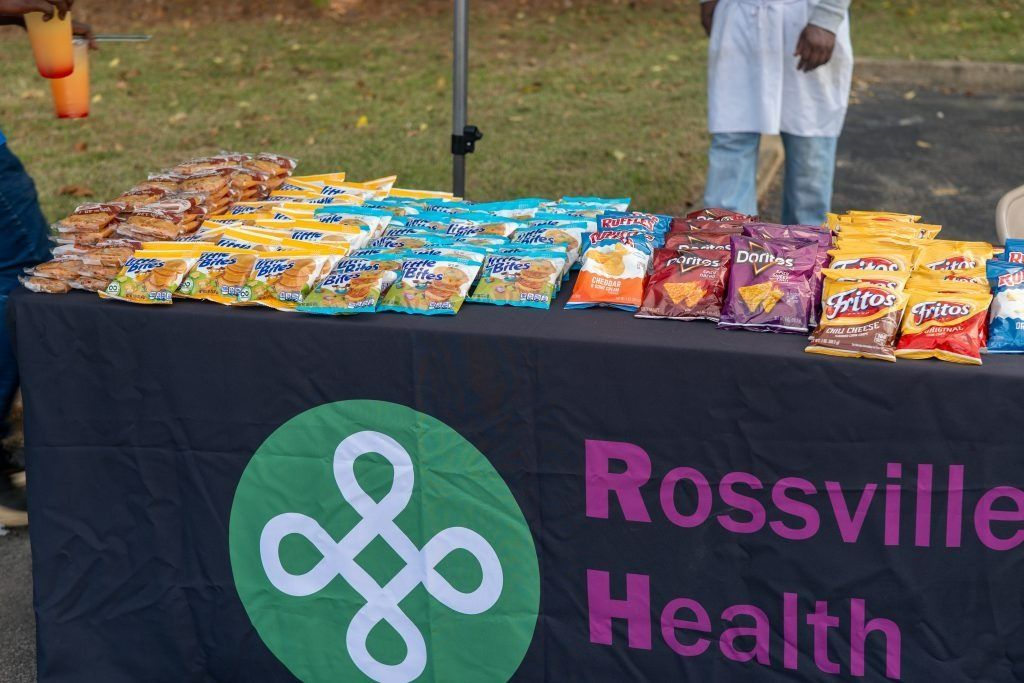 Rossville Health table with colorful snack bags at an outdoor community event