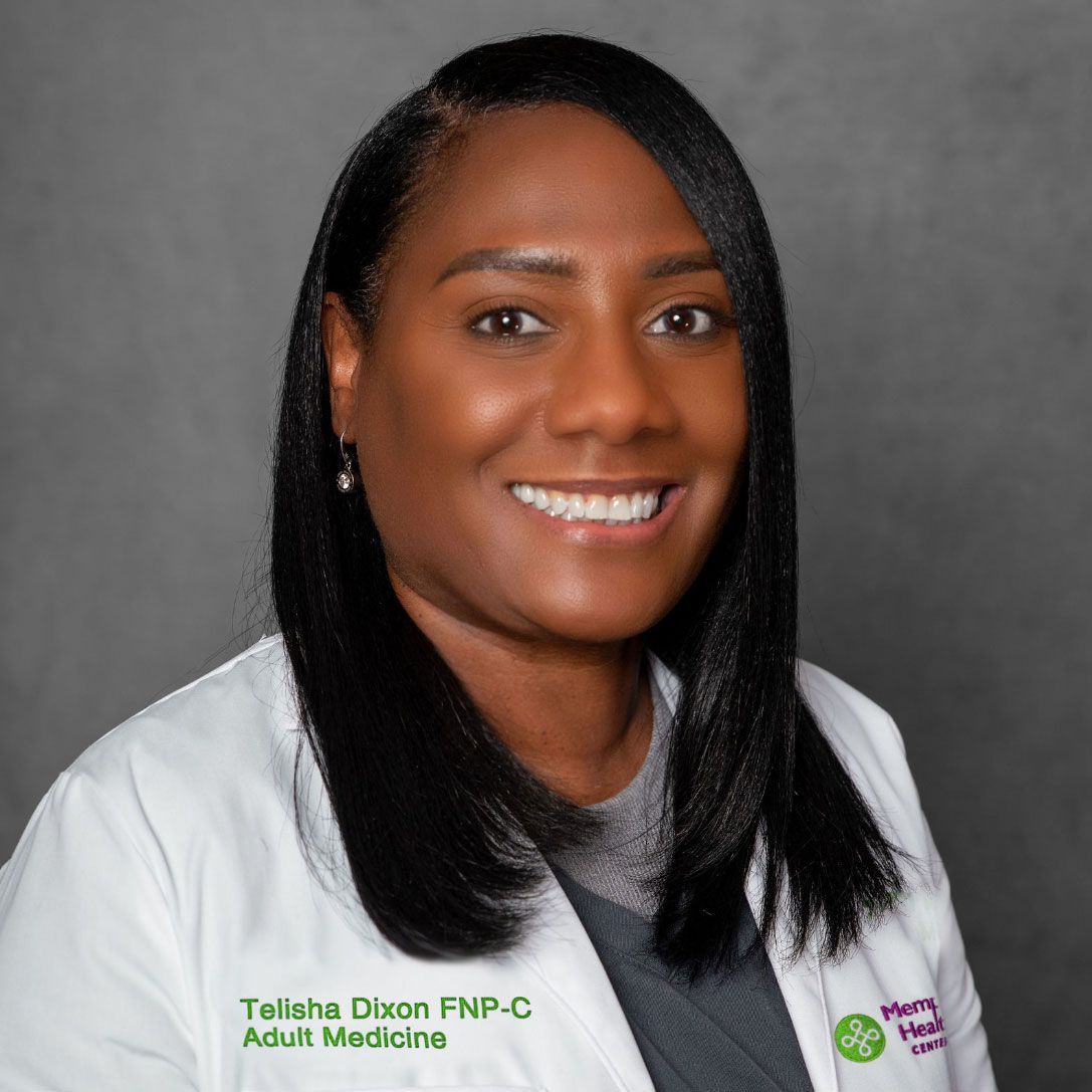 Portrait of a smiling clinician in a white coat against a gray background