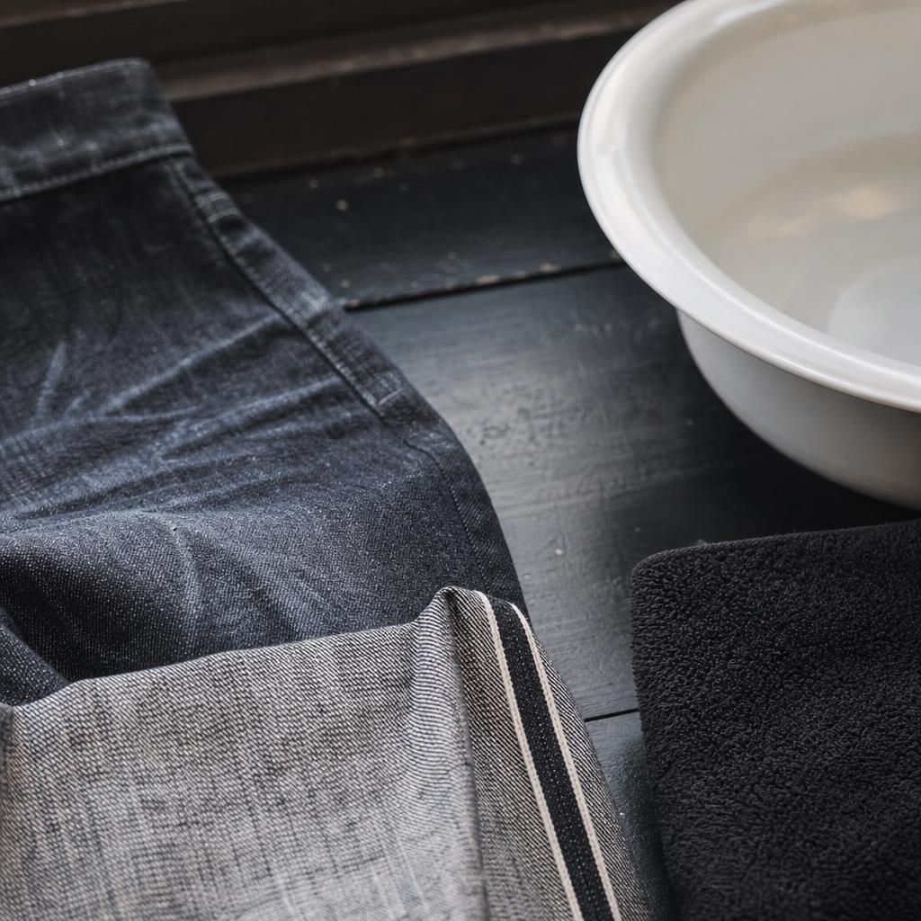Close-up of deadstock denim texture beside basin and towel