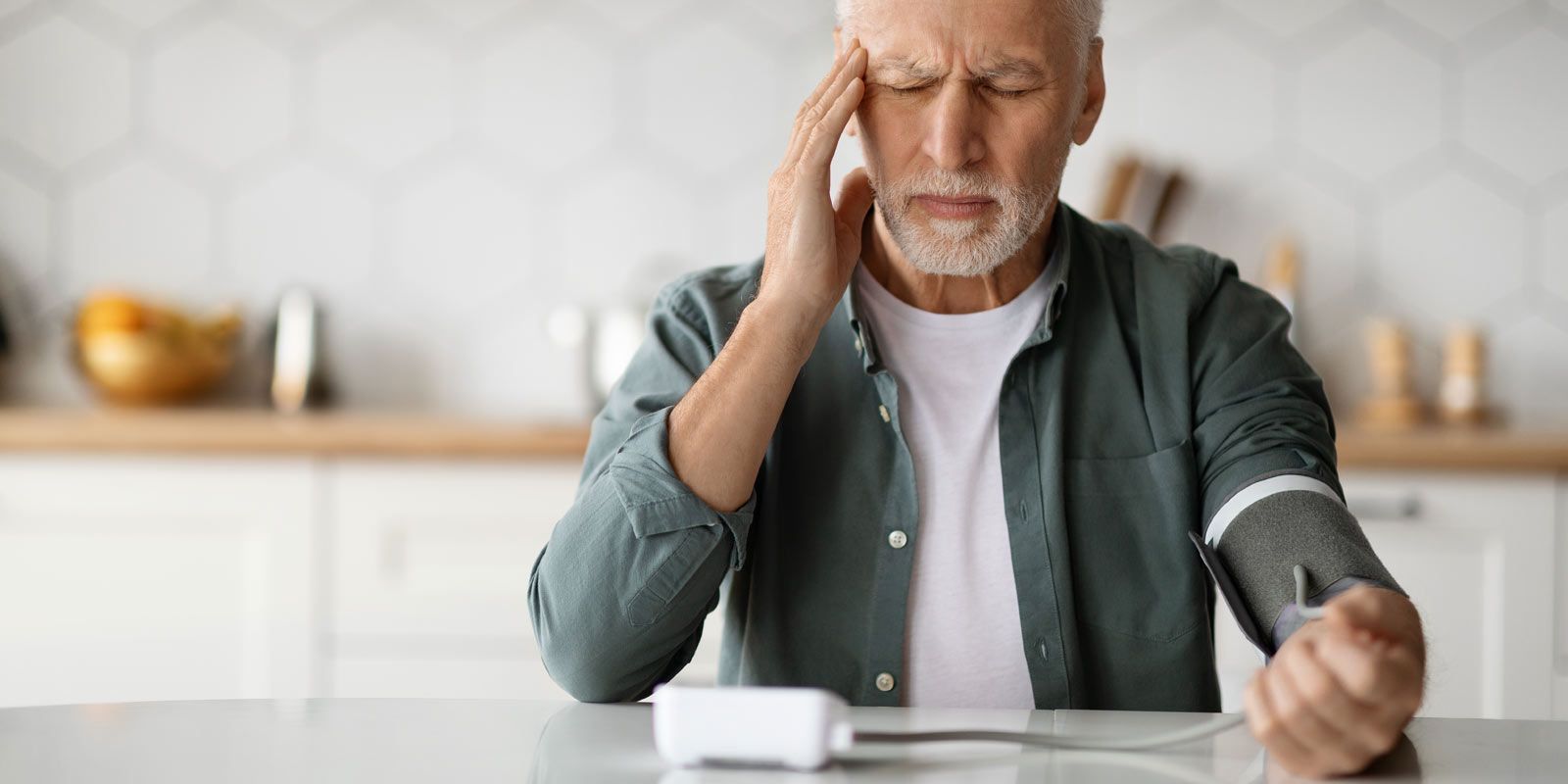 Man with stress and blood pressure monitor seeks Hypertension Treatments NYC - Marc Bystock L.Ac.