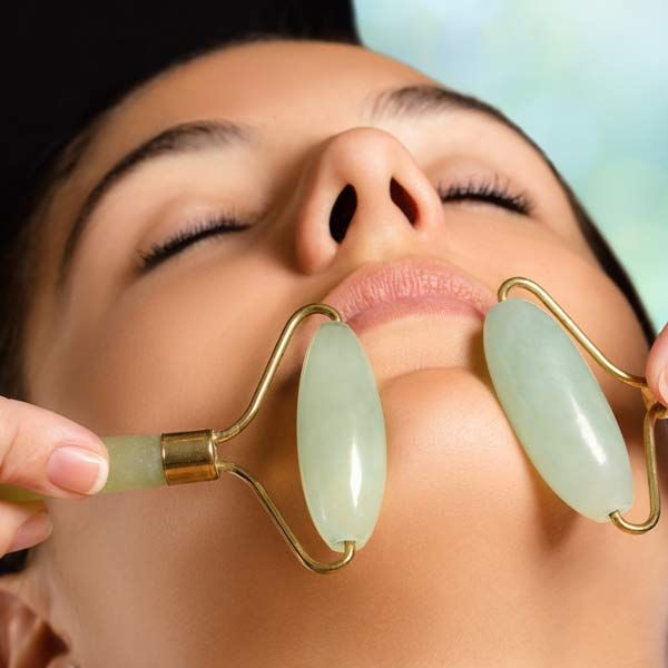 Woman receiving a Jade Rolling Therapy treatment session