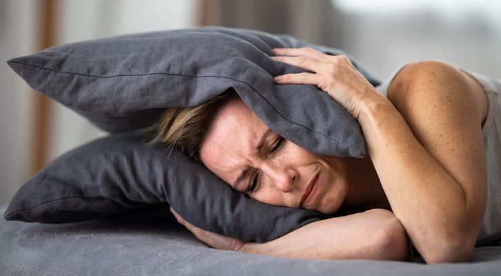 Woman needing Tinnitus Relief NYC by Marc Bystock L.Ac.