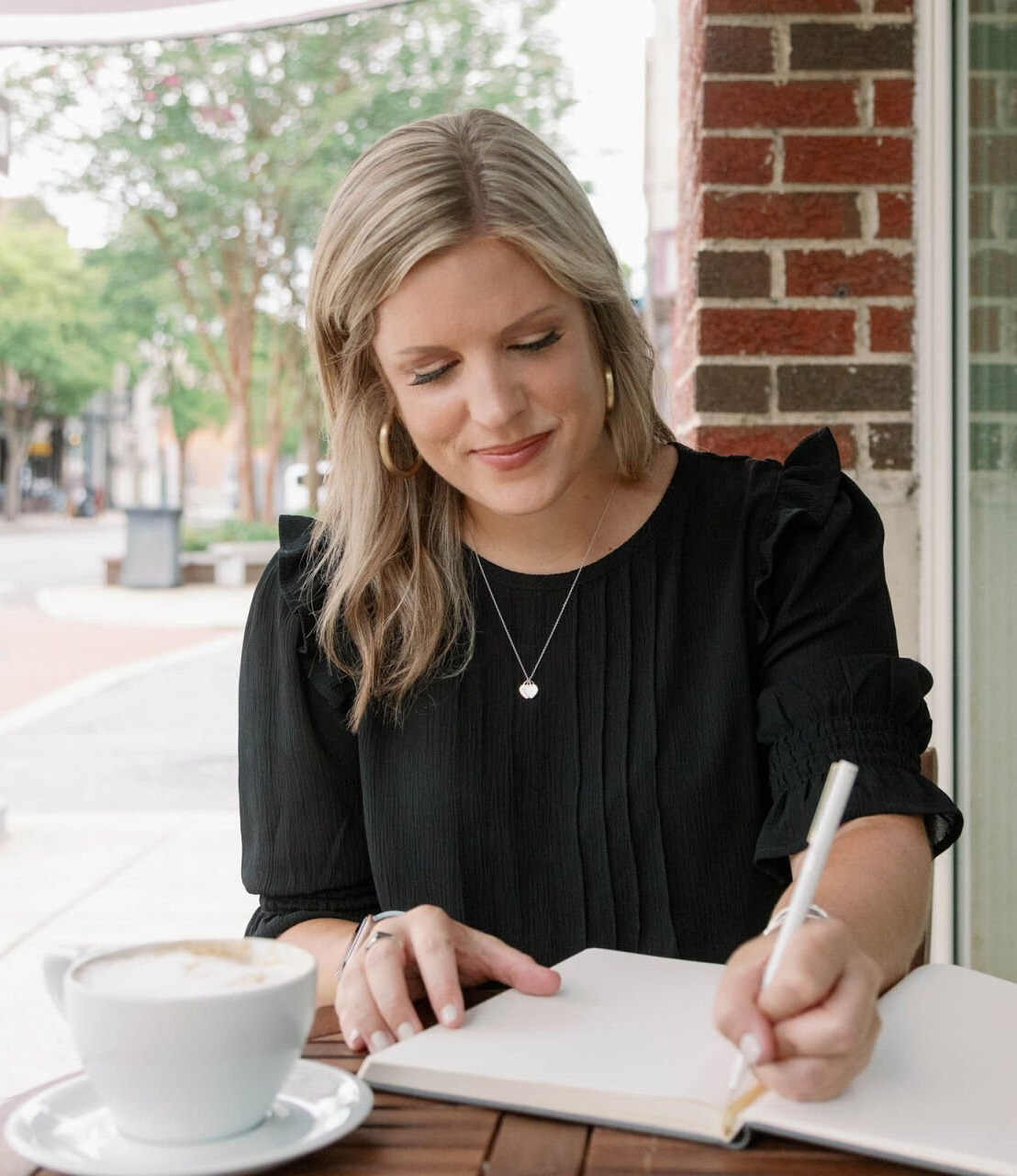 Leigh making notes outdoor cafe