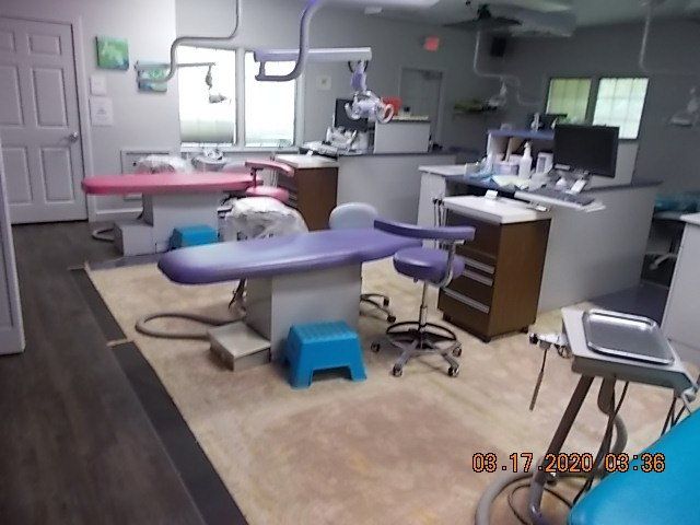 Dental office with two patient chairs, equipment, and tools.