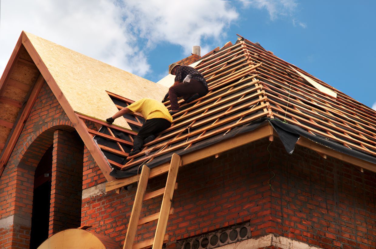 Two Men Are Working on the Roof of a Brick House — Goonellabah Roof Tilers in Bangalow, NSW