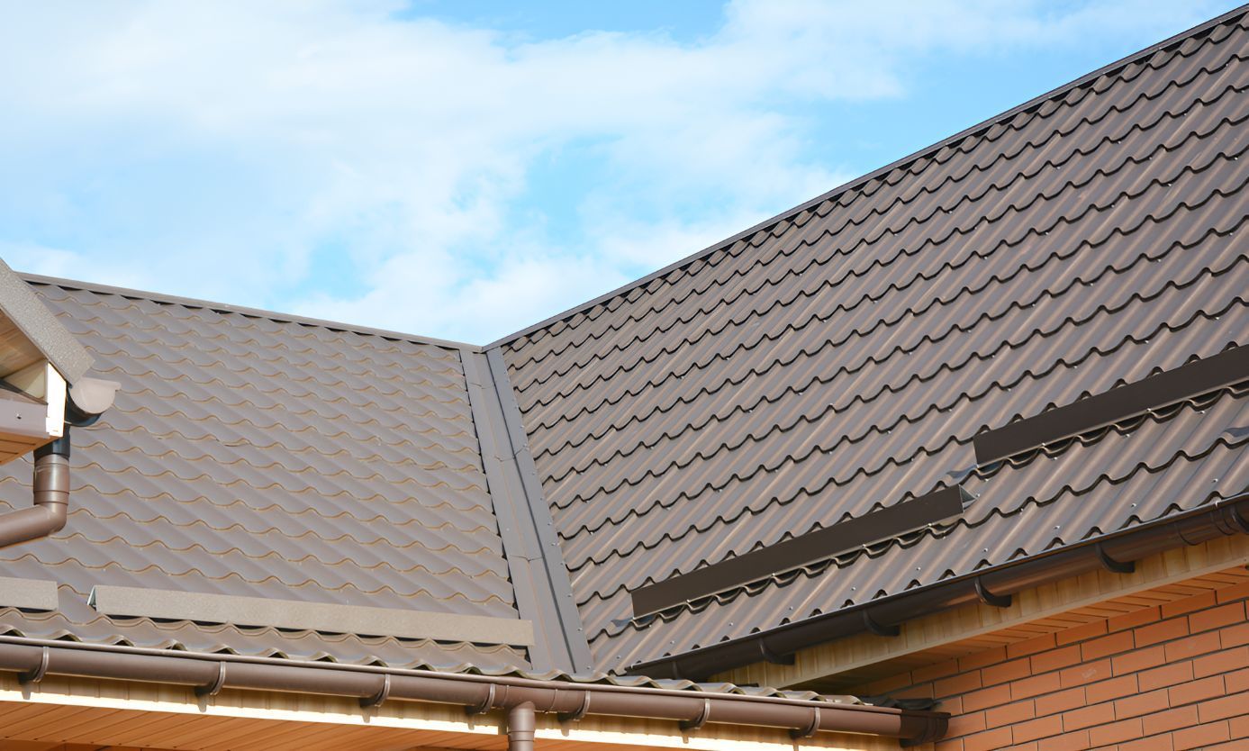 A Close Up of a Roof of a House With a Blue Sky in the Background — Goonellabah Roof Tilers in Lennox Head, NSW