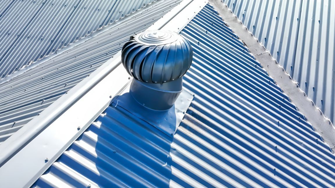 A Blue Roof With a Turbine on Top of It — Goonellabah Roof Tilers in Mullumbimby, NSW