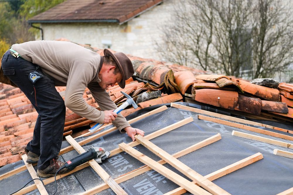 Roofer on Roof Covering It With Tiles Using Hammer — Goonellabah Roof Tilers In Ballina, NSW