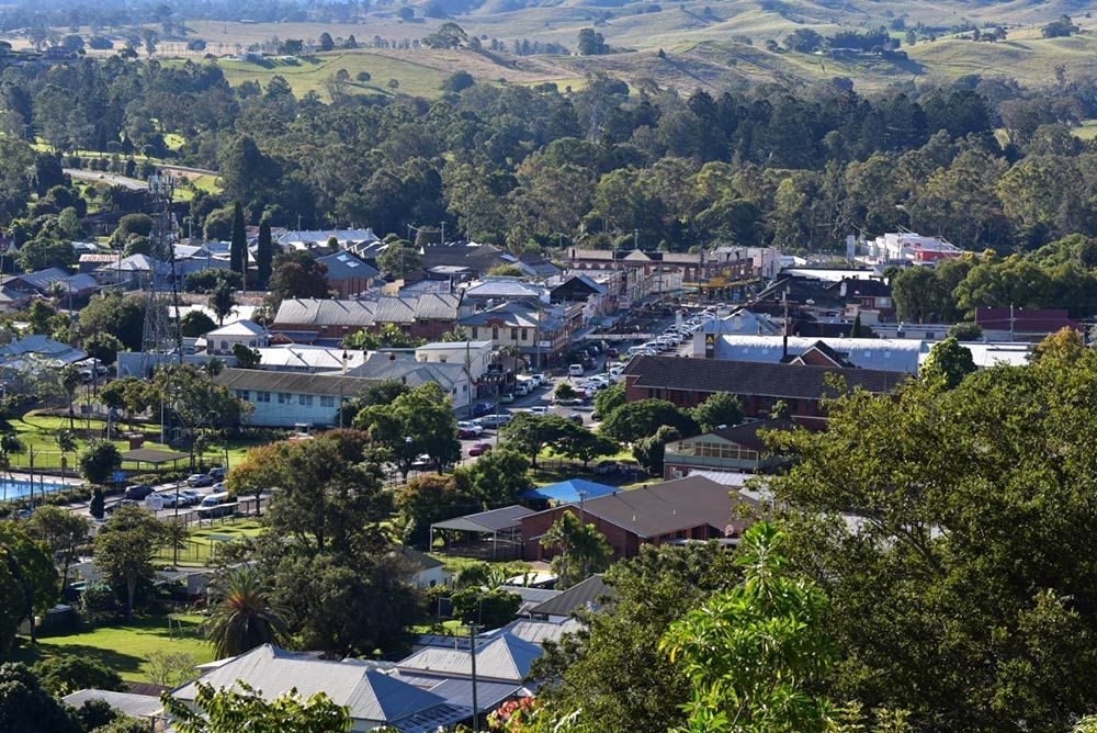 An Aerial View Of A Small Town Surrounded By Trees 