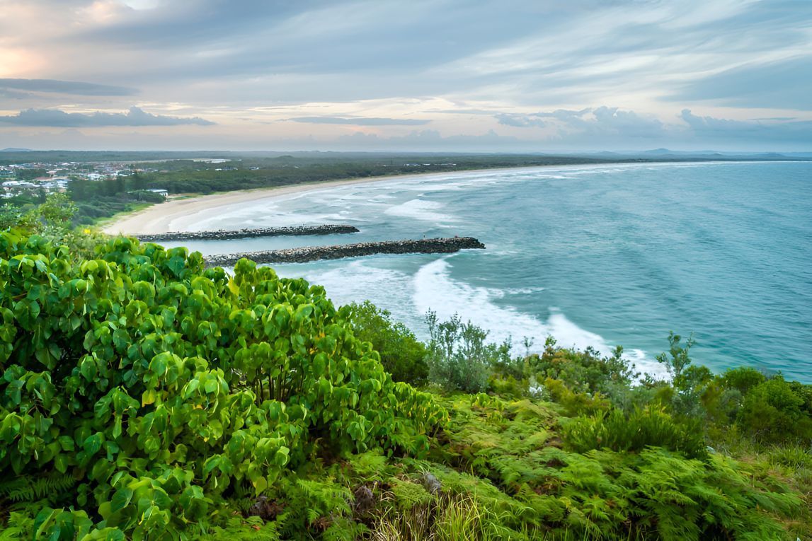 A View Of A Beach From A Cliff Overlooking The Ocean