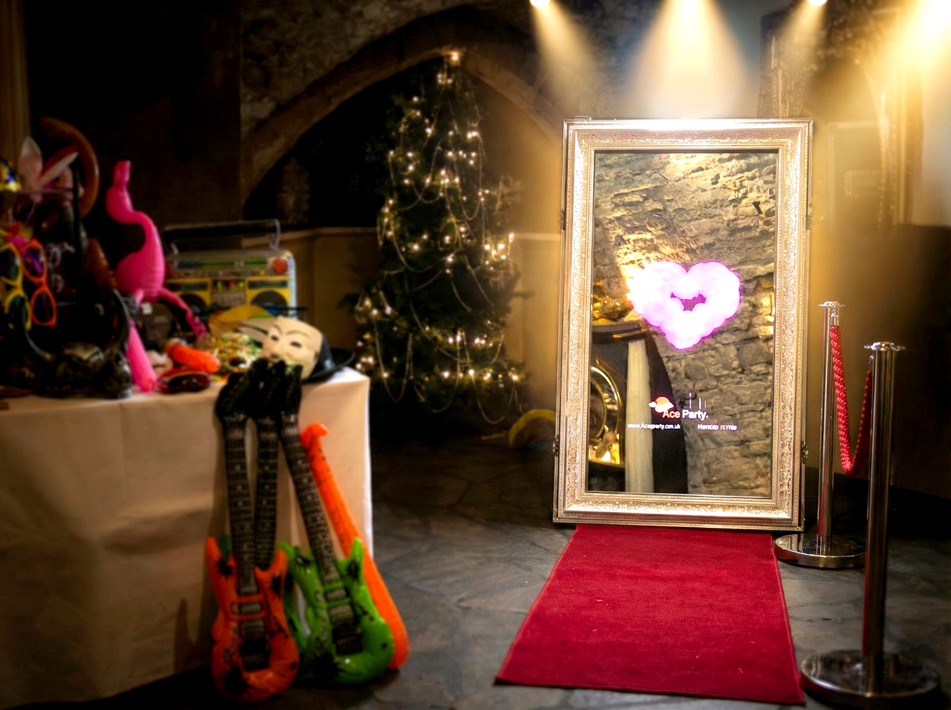 Ace Party Magic Mirror Photo Booth Hire setup with red carpet and props at an indoor event venue