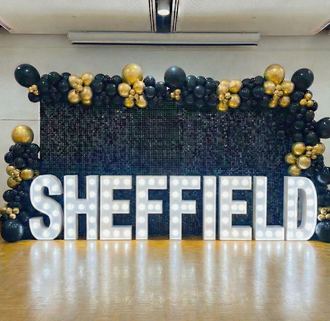 Ace Party premium black and gold event styling with sequin wall and light-up letters in Sheffield