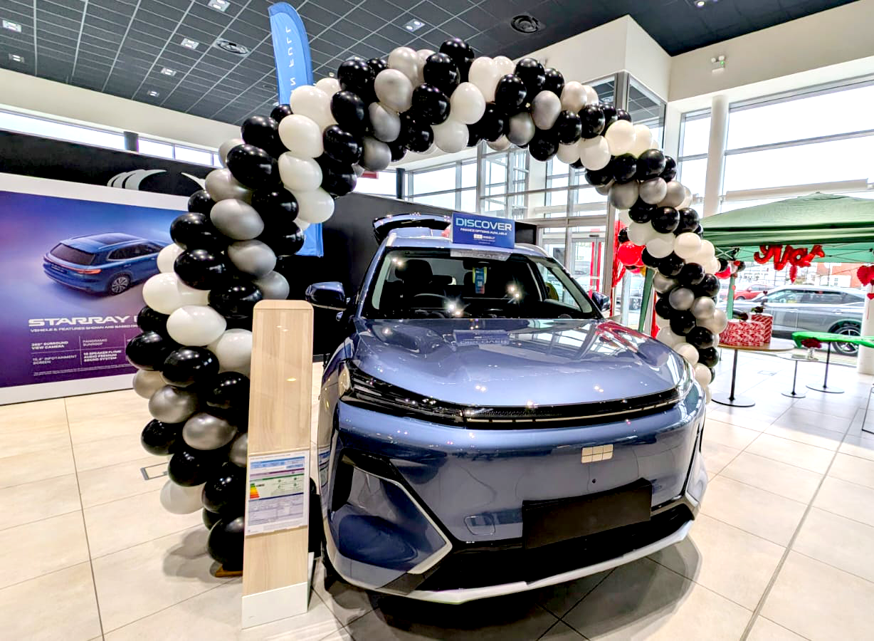 Balloon arch installation by Ace Party at a car showroom in South Yorkshire