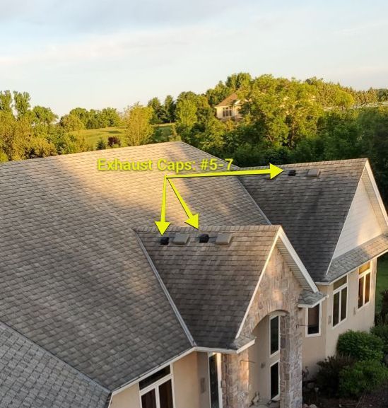 Aerial view of a house roof with yellow arrows marking roof caps and a ridge vent.