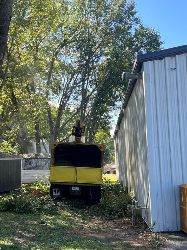 a yellow truck is parked in front of a white building .
