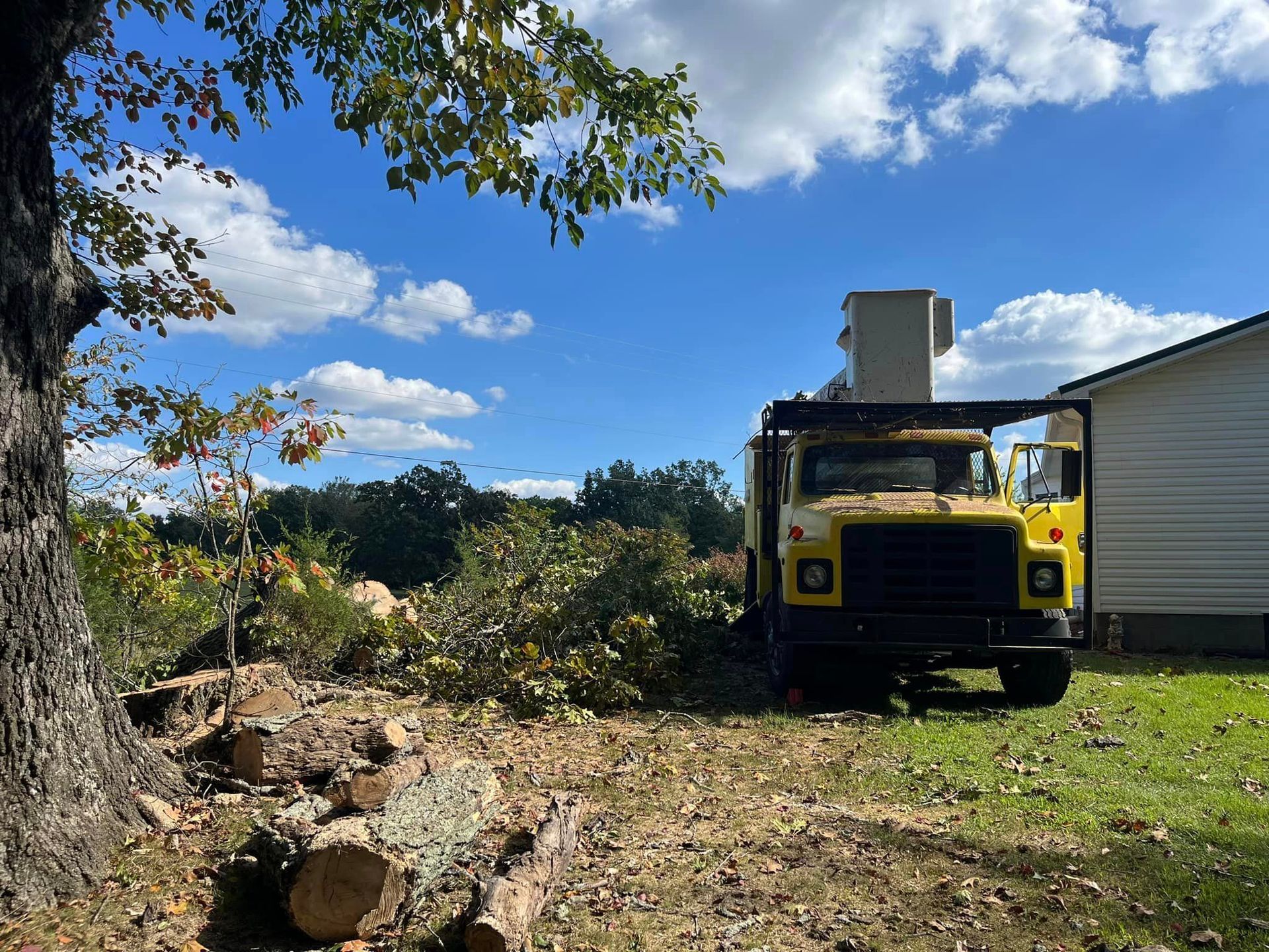 a yellow truck is parked in front of a house .