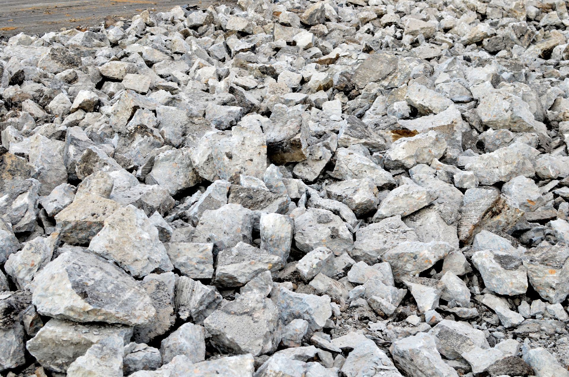 Pile of broken concrete rubble, gray tones, outdoors.
