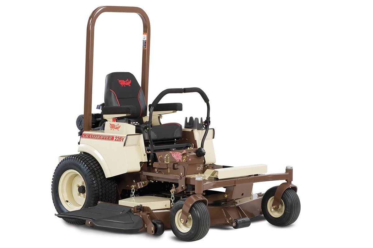 a brown and white lawn mower with a red eagle on the seat
