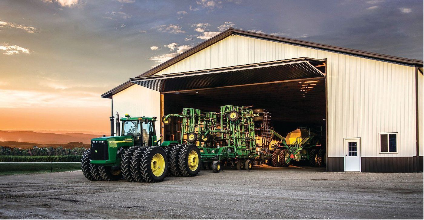 Tractor Pulling Out Of Large Barn