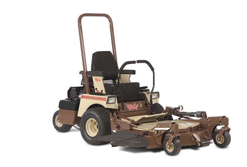 a brown and tan lawn mower with a black seat