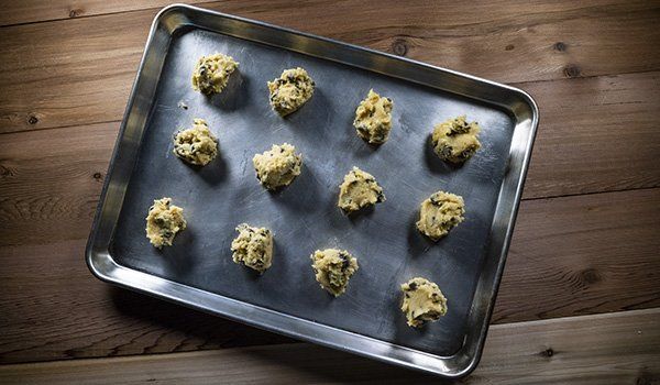 A pan filled with cookie dough on a wooden table.