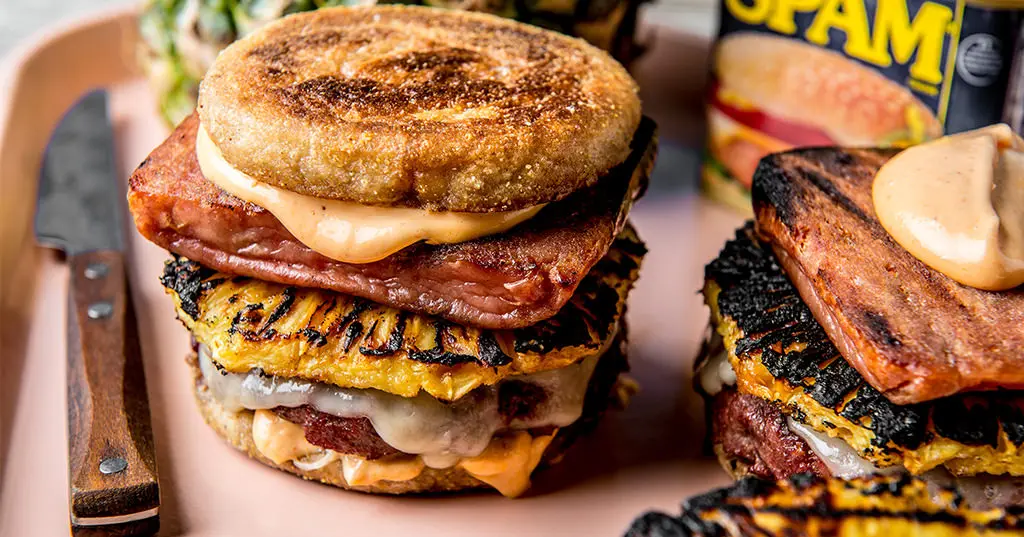 A Hawaiian burger with a spam container in the background
