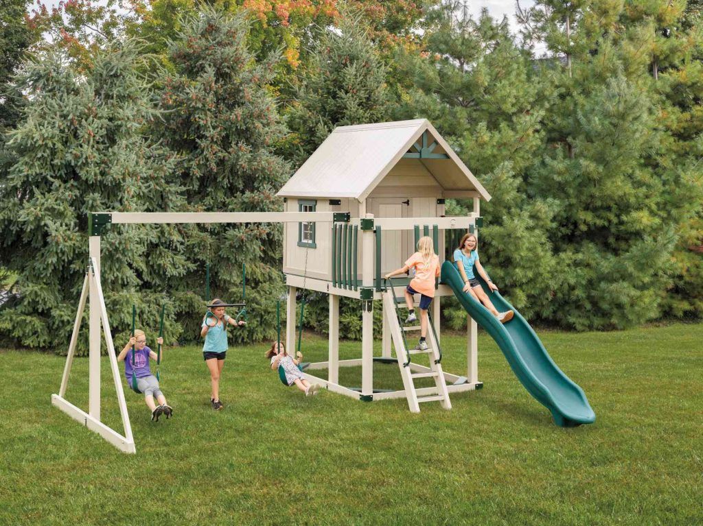 A group of children are playing on a swing set with a slide.